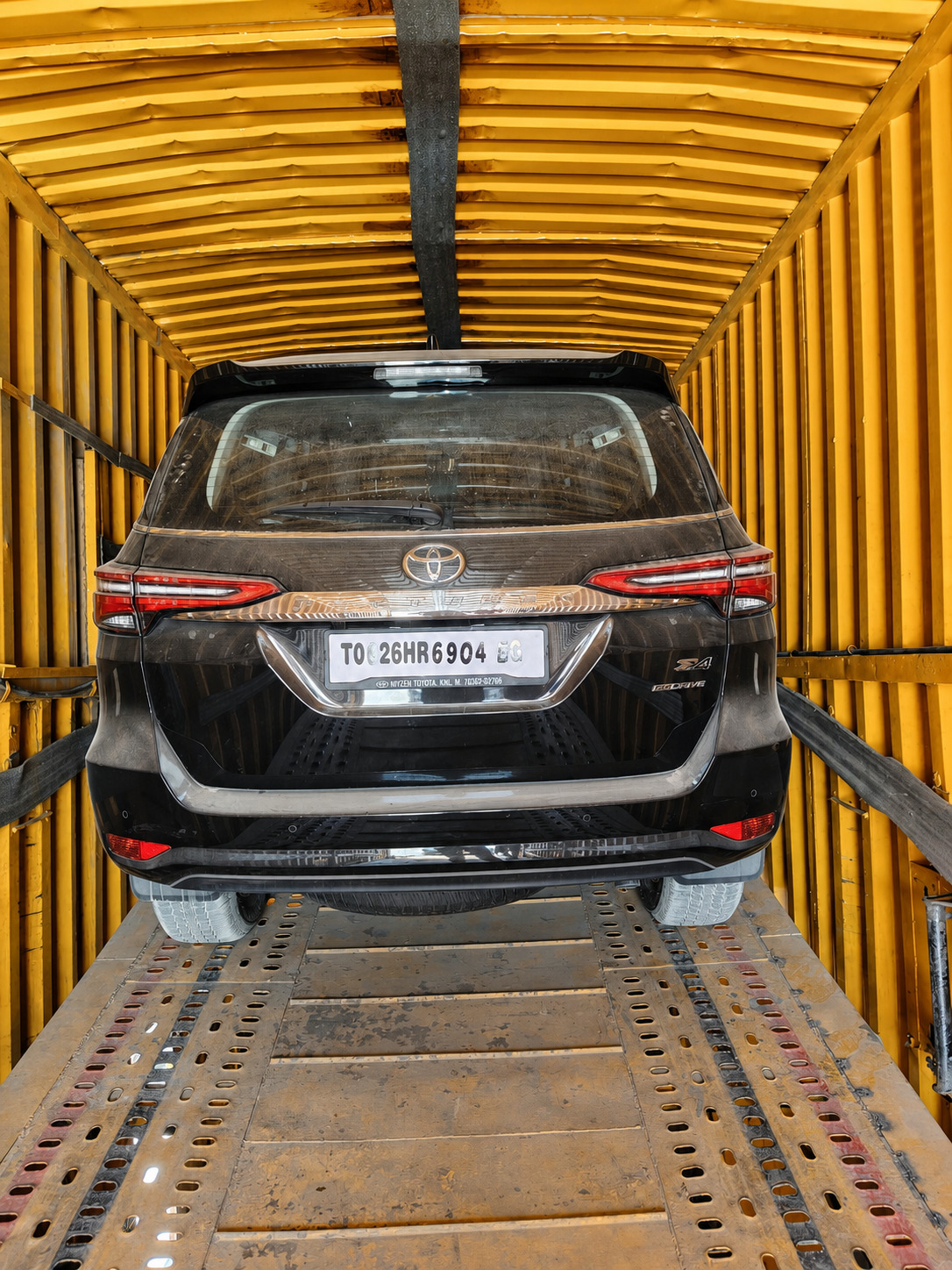 Toyota Fortuner, loaded and locked down for an enclosed-carrier move.