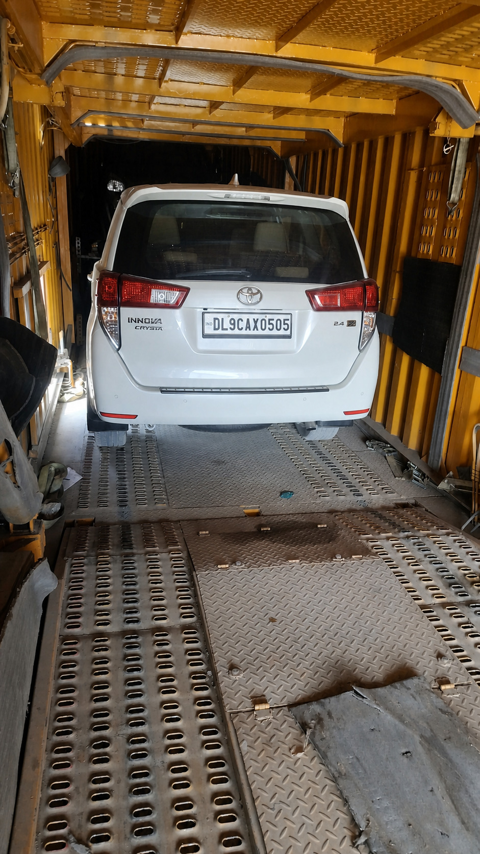 Toyota Innova Crysta, strapped down and container-sealed.
