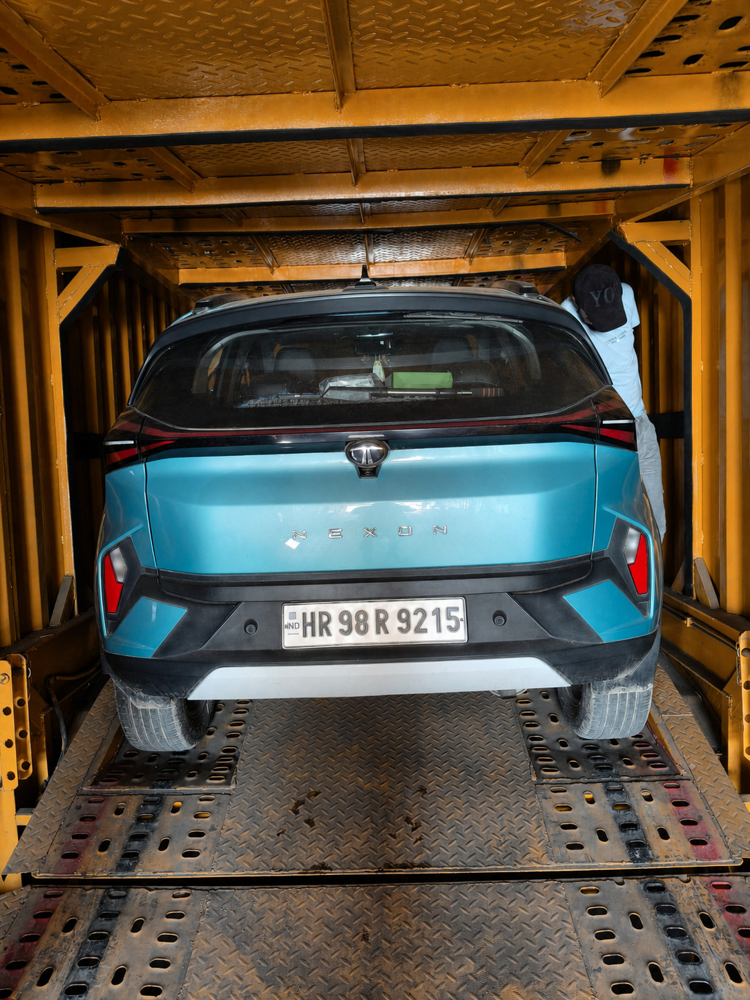 Our crew finishing off the tie-down on a Tata Nexon before the doors close.