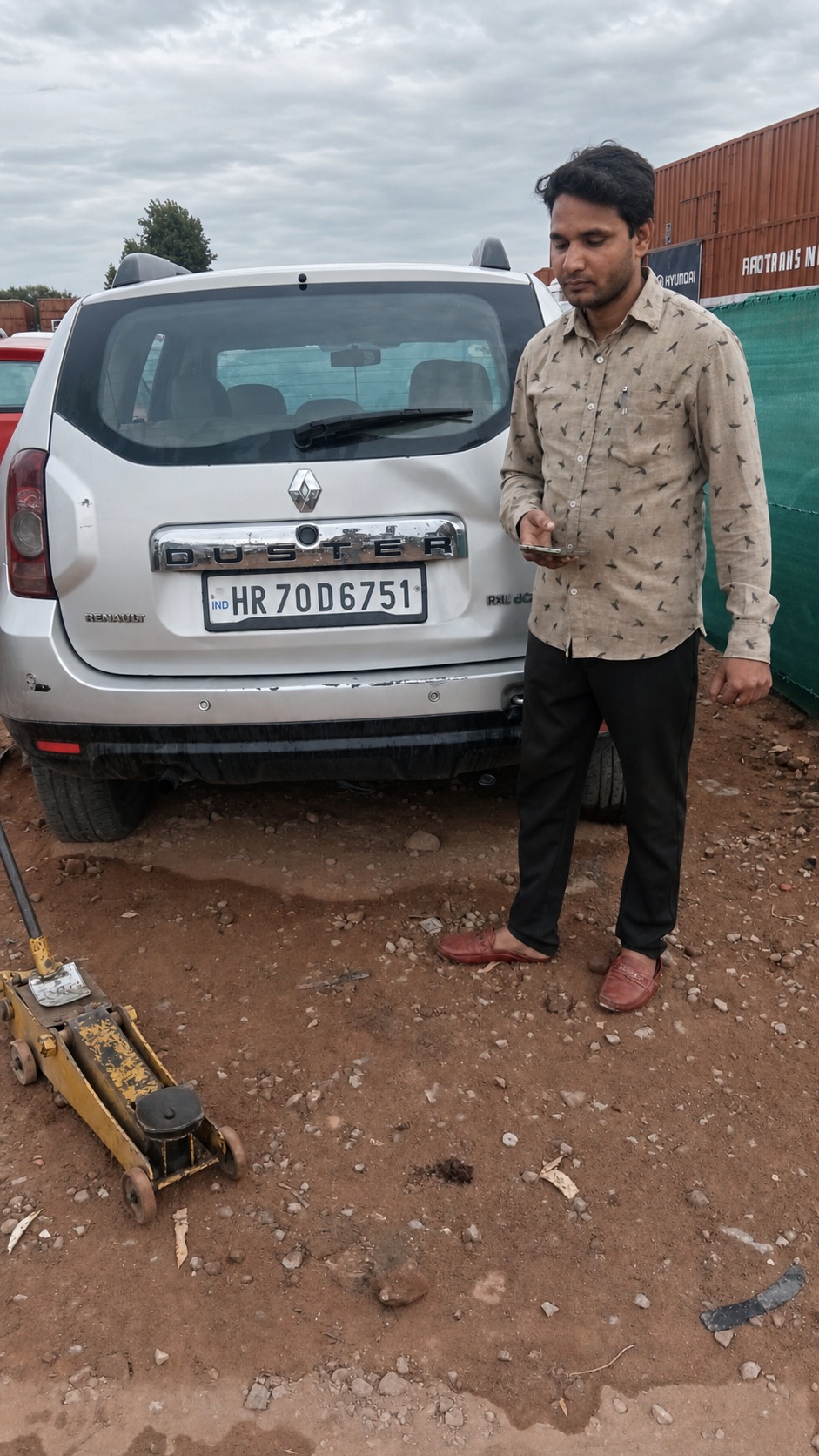 Checking the paperwork against a Renault Duster before it goes on the carrier.